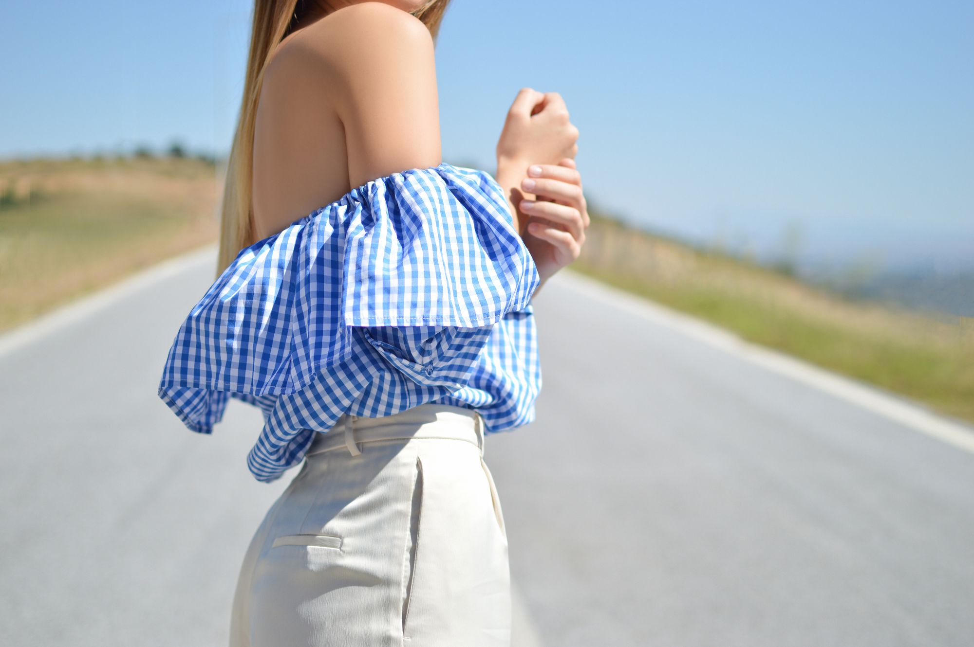 A woman wearing a shirt made out of printed organic quilting cotton fabric printed by Art Fabrics.